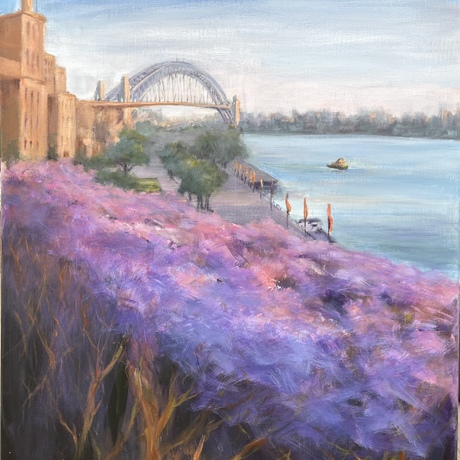 Sandstone glows warmly in the summer sun, drenching the harbour and a riot of jacarandas in summer sun