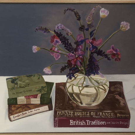 Flowers in circular vase on book stack