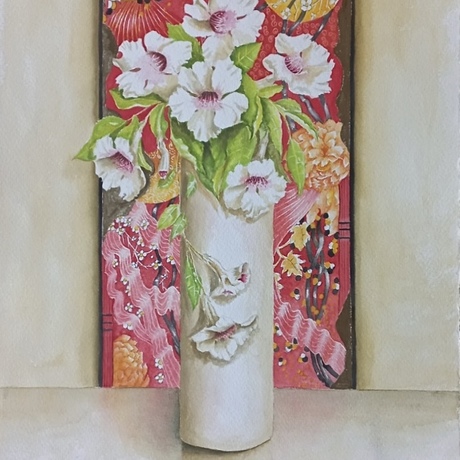 This is a painting of a tall white vase holding white and pink flowers. The vase also contains bright green foliage and two of the flowers trail downwards over the side of the vase. It is a still life painting, and the vase of flowers is sitting on a reflective white marble table. A Japanese textile is hanging on the wall behind the vase of flowers as the backdrop of the painting, and it has intricate red, yellow, pink and black patterns.