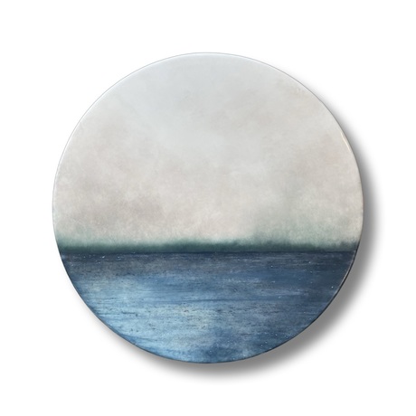 Porthole blue ocean horizon with light sky.