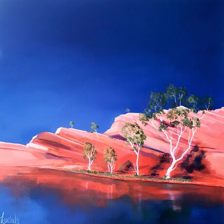 Australian landscape in oranges and deep blue sky with  gum trees and water reflections