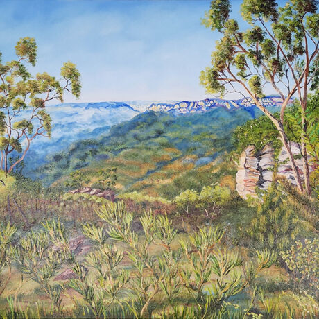 gum trees and various shrubs in the foreground with the bridal veil cliffs, the jamison valley and the distant blue shimmering valleys beyond with parts of the massive mount solitary