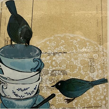 One bird sitting on a stack of tea  cups Looking down at another bird on the ground with a background of vintage dress patterns and dental of Stencil doilies