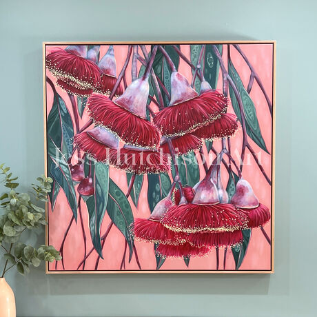 Red Silver princess flowering gum blossoms against a blush pink background and green patterned leaves