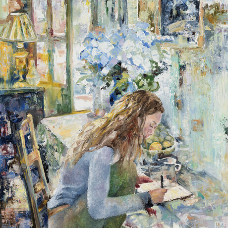 a woman sits at breakfast table writing in her notebook. Behind her a vase of Hydrangeas and light pouring through French doors