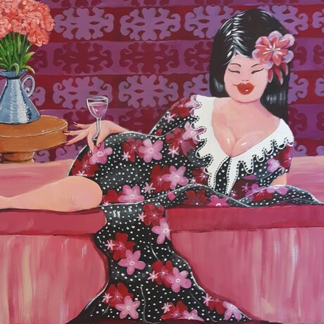 Woman reclining on a lounge drinking rose wine