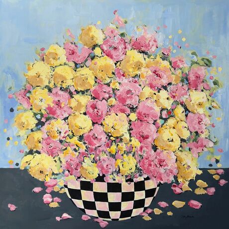 Bright Pink Yellow  flowers bursting in full bloom in a black checkered bowl or vase