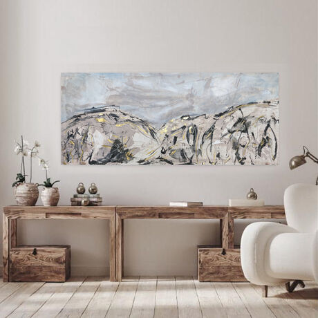 A large abstract painting of mountains and cloudy sky. Charcoal black, a very deep brown/black, metallic gold leaf gilding,  tan, warm cream, beige and white with shades of grey.