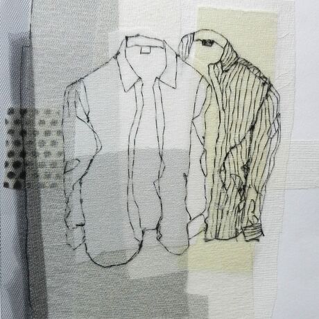 A white shirt and a striped shirt depicted in black thread with grey background on the left.