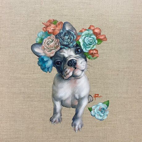 A grey and white French Bulldog puppy wearing a flower crown.