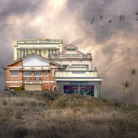 A complex of similar buildings of retro and art deco architecture fused together as one sharing a grassy hill setting and textured moody sky background. A flock of  birds fly by plus a lone pandanus palm decorates the hill.