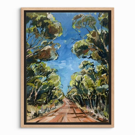 A red track is bordered by swaying gumtrees that make an archway.  There is a blue sky. 