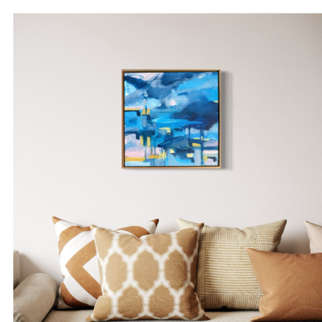 Two small row boats against an expressive abstract blue sky storm out on the blue ocean