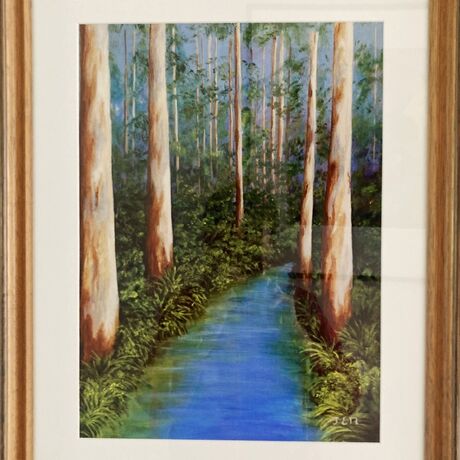 A peaceful blue stream wends its way through the stately tall karri trees in a southwest forest. The background sky peeps through the green undergrowth while the stately trees stand in solidarity along the water's edge. Bracken, ferns and ground covers frame the blueness of the water providing peaceful reflections in the slow moving stream. It is a peaceful scene to encounter.