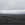 grey sky black volcanic sand landscape mountains in the distance