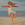 Young  girl running arms outstretched on beach