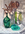 Painting of coloured glass bottles and vase with dried protea and dramatic lighting on a white background