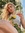 A portrait of a woman sitting in the sun picking sunflowers