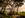 Sunrise view of Palm Cove beach from behind trees with island silhouettes on the horizon, golden hue
