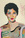 A large portrait of a beautiful, short haired woman. Her face is formed using a range of neutral and pastel colours, her expression is determined. She is beautiful. 