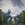 A young boy climbs a ladder to ride an incredibly large Balloon Dog set within a topiary garden.