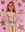 Semi nude lady standing with a pink background and metallic gold stars