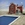 A red brick heritage building alongside a swimming pool.