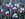 Australian eucalyptus pink blossoms with grey branches and green leaves on a dramatic dark sky background. 