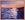 Sunset seascape in bright orange and dark blue.