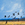 Black cockatoos flying against a blue sky, distant mountain ranges of Alice Springs and sun bleached grasses