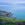 The view looking down over the national park flora to the rocks of Noosa National Park, out to the horizon and sky. 