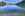 Lake Wakatipu in Queenstown, New Zealand. Clear water and reflections of sky and clouds. Mountatins in the distance