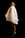 A young woman stands on tiptoes looking haughtily down at the viewer  She wears a cream dress and stands against a black background.