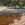 Rocky river scene with  running water and rocks submerged as well as visible above water.