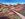 The Kennedy Ranges are in the background. A path winds through the ranges. Dry grasses are in the foreground. The