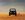 Stylised 4WD and dingo on an open desert plain