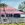 old Queenslander style home with sky and trees and white picket fence