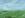 Blurred shimmering landscape. Blurred green grass landscape. Abstract landscape