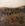 Hill, trees, rocks in foreground, hills in the distance