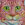 Portrait of the face of a pink cat with yellow eyes.