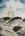 White lighthouse on a sandy hill against a blue cloudy sky