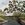 River surrounded by grass and trees with dark glassy surface in the early morning light. 
