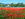 Landscape painting with a field of red poppies and a Mediterranean villa