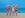 Four blonde women in red bathing costumes on the beach