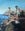 Three men fishing, they are fishing on the rock face, facing outward to the ocean. The blue scenery compliments the bright sun that is reflected off the men. The cliffs in the background explore the tranquillity of such a peaceful activity.