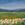 impressionistic flowers, mountains and fields in this textured landscape