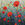 Textured red and pink poppies in an abstract field of blues and greens. 