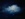 A lone softly billowing white cumulus cloud drifting against a midnight blue sky.  Contrasting  light and dark w