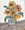 A glass vase full of sunflower on a white and brown background 