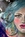 Dramatic painting of a model's face with blue hair wearing ornate earrings. She's big and bold and a real statement piece.  Only one side of her face is shown on the canvas. Easy to hang. You just need a hook on the wall.